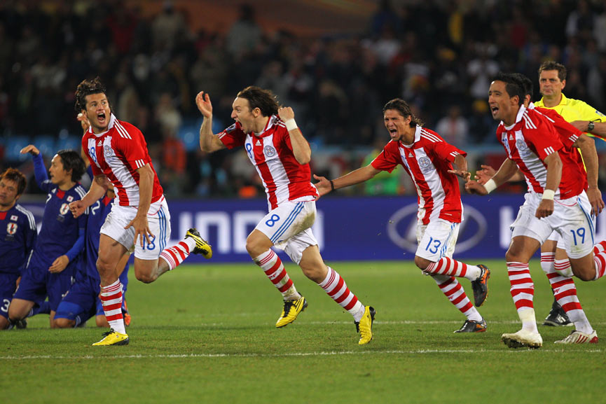 Paraguay players celebrate their penalty shoot-out victory over Japan.